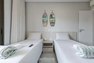 Uma cama ou camas num quarto em DRL - Apartamentos a 300m da Praia de Bombinhas