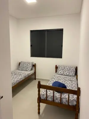 Uma cama ou camas num quarto em Lindo Sobrado em Camboriú