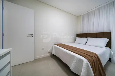 Uma cama ou camas num quarto em Apartamento com 2 quartos Bombinhas