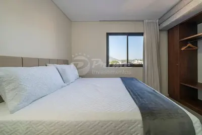 Uma cama ou camas num quarto em Apartamento com 2 quartos Bombinhas