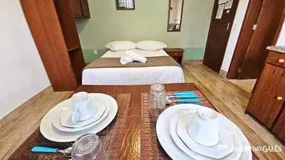 Uma cama ou camas num quarto em Jardim das Gales Bombinhas
