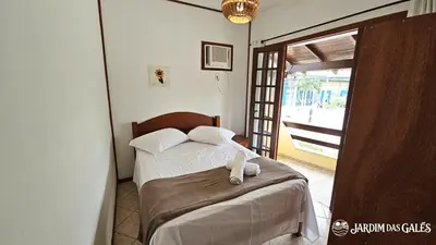 Uma cama ou camas num quarto em Jardim das Gales Bombinhas
