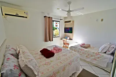 Uma cama ou camas num quarto em Pousada Enseada dos Golfinhos