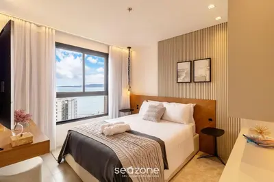 Uma cama ou camas num quarto em MHF II - Apts Variados em Prédio com Vista para o Mar em Itapema