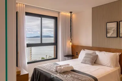 Uma cama ou camas num quarto em MHF II - Apts Variados em Prédio com Vista para o Mar em Itapema