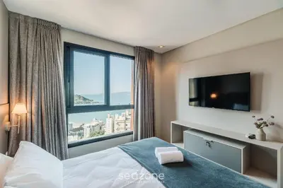 Uma cama ou camas num quarto em MHF II - Apts Variados em Prédio com Vista para o Mar em Itapema