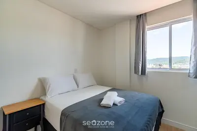Uma cama ou camas num quarto em CII - Apartamentos a 900m da Praia em Porto Belo