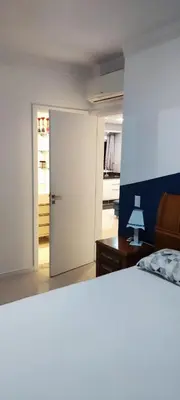 Uma cama ou camas num quarto em AP completo na Praia de Palmas, SC