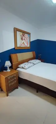 Uma cama ou camas num quarto em AP completo na Praia de Palmas, SC