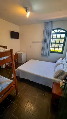 Uma cama ou camas num quarto em Pousada
