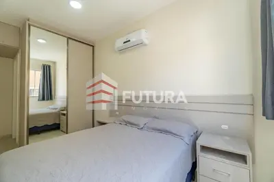 Uma cama ou camas num quarto em Apartamento para aluguel de temporada Bombas,SC