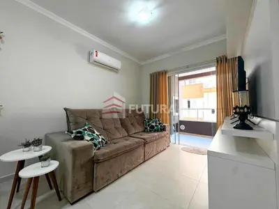 Uma televisão e/ou sistema de entretenimento em Apartamento para aluguel de temporada Bombas,SC
