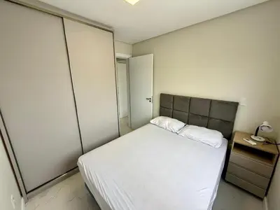 Uma cama ou camas num quarto em Apartamento espaçoso na Praia de Palmas SC 05