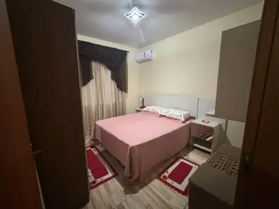 Uma cama ou camas num quarto em Casa de Praia Bombinhas