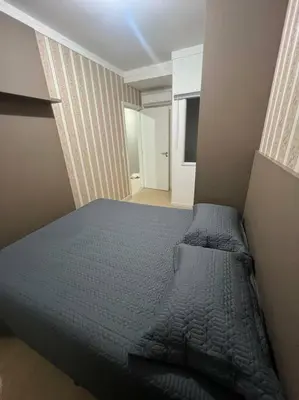 Uma cama ou camas num quarto em Apartamento Porto Belo - Perequê