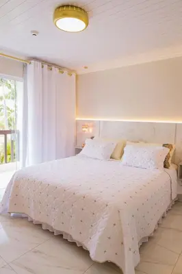 Uma cama ou camas num quarto em Pousada Áurea