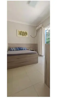 Uma cama ou camas num quarto em Apartamento-Garden Bombinhas
