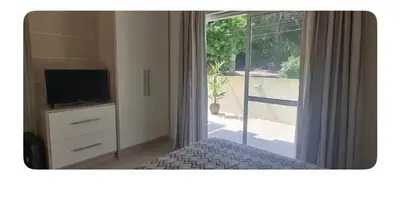 Uma televisão e/ou sistema de entretenimento em Apartamento-Garden Bombinhas