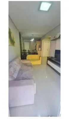 Uma área de estar em Apartamento-Garden Bombinhas
