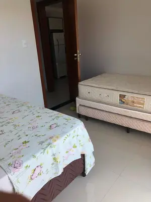 Uma cama ou camas num quarto em Bombinhas Residencial Ecomar