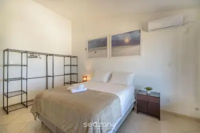Uma cama ou camas num quarto em Casa 6Q pé na areia em Bombinhas ABM0101