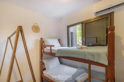 Uma cama ou camas num quarto em Casa 6Q pé na areia em Bombinhas ABM0101