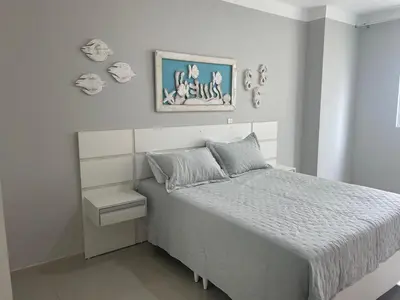 Uma cama ou camas num quarto em Apartamento em Itapema