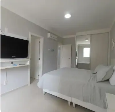 Uma cama ou camas num quarto em Apartamento em Itapema
