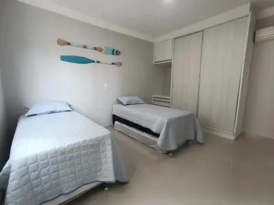 Uma cama ou camas num quarto em Apartamento em Itapema
