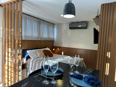 Uma cama ou camas num quarto em Loft para Casal em Bombinhas - Sem Garagem