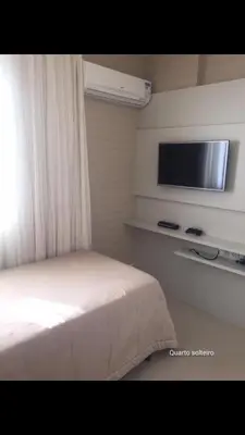 Uma cama ou camas num quarto em Frente Mar Aconchegante