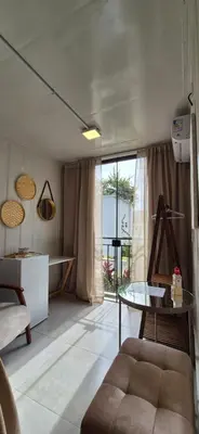 Uma área de estar em Loft aconchegante próximo do mar e do Expocentro