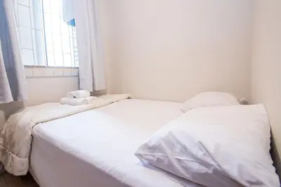 Uma cama ou camas num quarto em Apto Rústico com Vista Lateral do Mar KZ7271