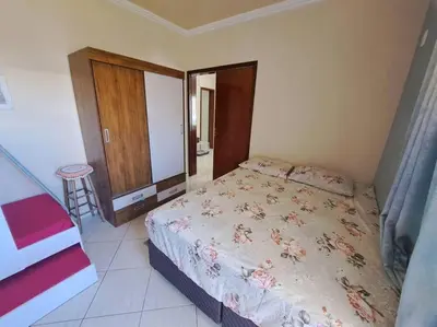 Uma cama ou camas num quarto em Praia de Palmas 2 Qtos 2 suítes