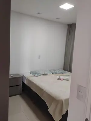 Uma cama ou camas num quarto em Apartamento alto padrão de 2 quartos com vista mar em itapema