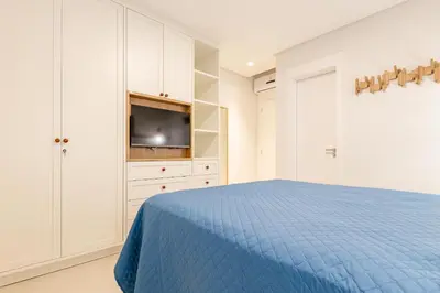 Uma cama ou camas num quarto em Apartamento alto padrão com piscina em Bombinhas