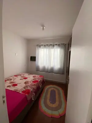Uma cama ou camas num quarto em Casa com tres dormitoria a uma quadra da praia