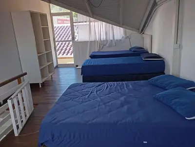 Uma cama ou camas num quarto em Pousada Morro do Macaco ARTE