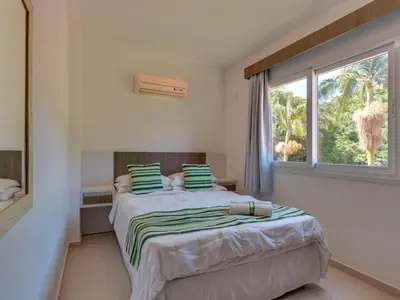 Uma cama ou camas num quarto em Villa Maciel Bombinhas