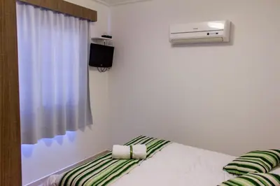 Uma cama ou camas num quarto em Villa Maciel Bombinhas