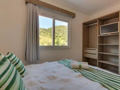 Uma cama ou camas num quarto em Villa Maciel Bombinhas