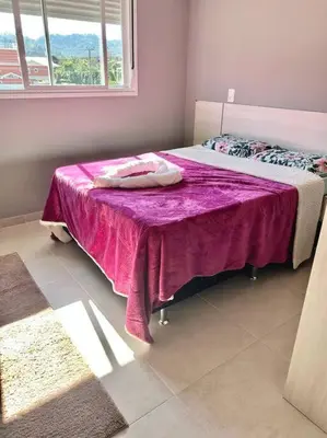 Uma cama ou camas num quarto em Apartamento na praia de palmas