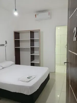 Uma cama ou camas num quarto em Pousada Morro dó Macaco ARTE