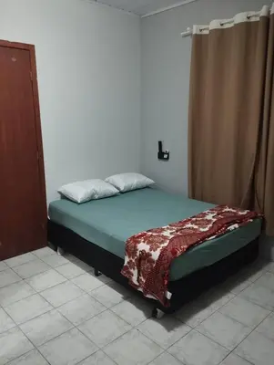 Uma cama ou camas num quarto em Casa 500 metros praia do centro