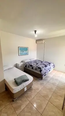 Uma cama ou camas num quarto em Casa Praia Palmas
