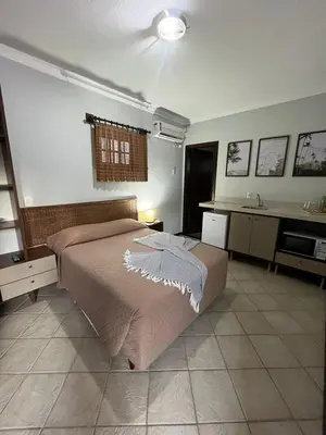 Uma cama ou camas num quarto em Pousada Sunny Coast