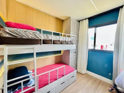 Uma ou mais camas em beliche num quarto em Cobertura na Praia de Palmas, a apenas 300 metros do mar.
