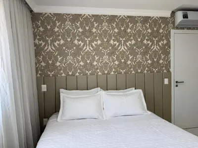 Uma cama ou camas num quarto em Aconchegante ap em Itapema