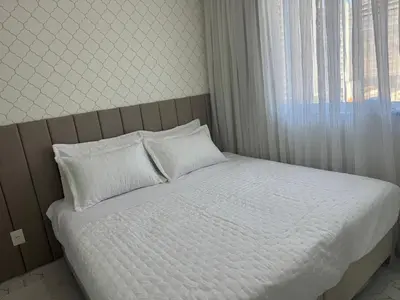 Uma cama ou camas num quarto em Aconchegante ap em Itapema