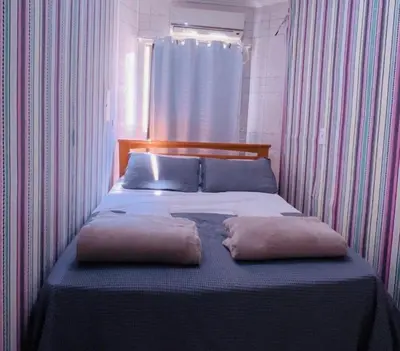 Uma cama ou camas num quarto em Cobertura com piscina a 80 mt da praia de Bombas